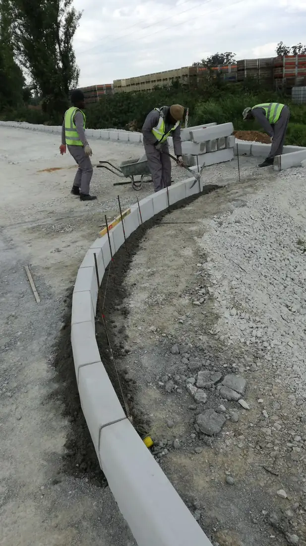 Laying precast kerbing on a new road