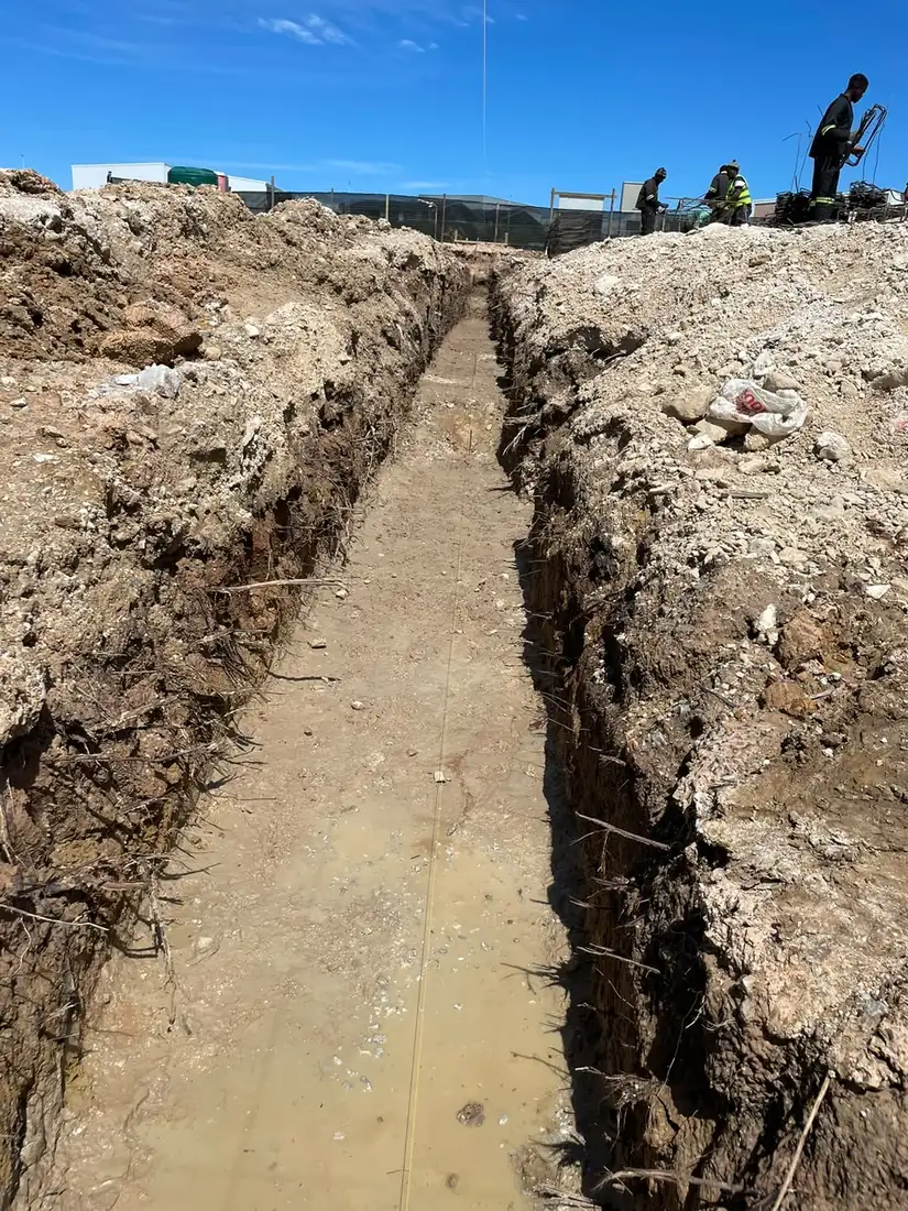 Excavators digging a service trench on a civil site